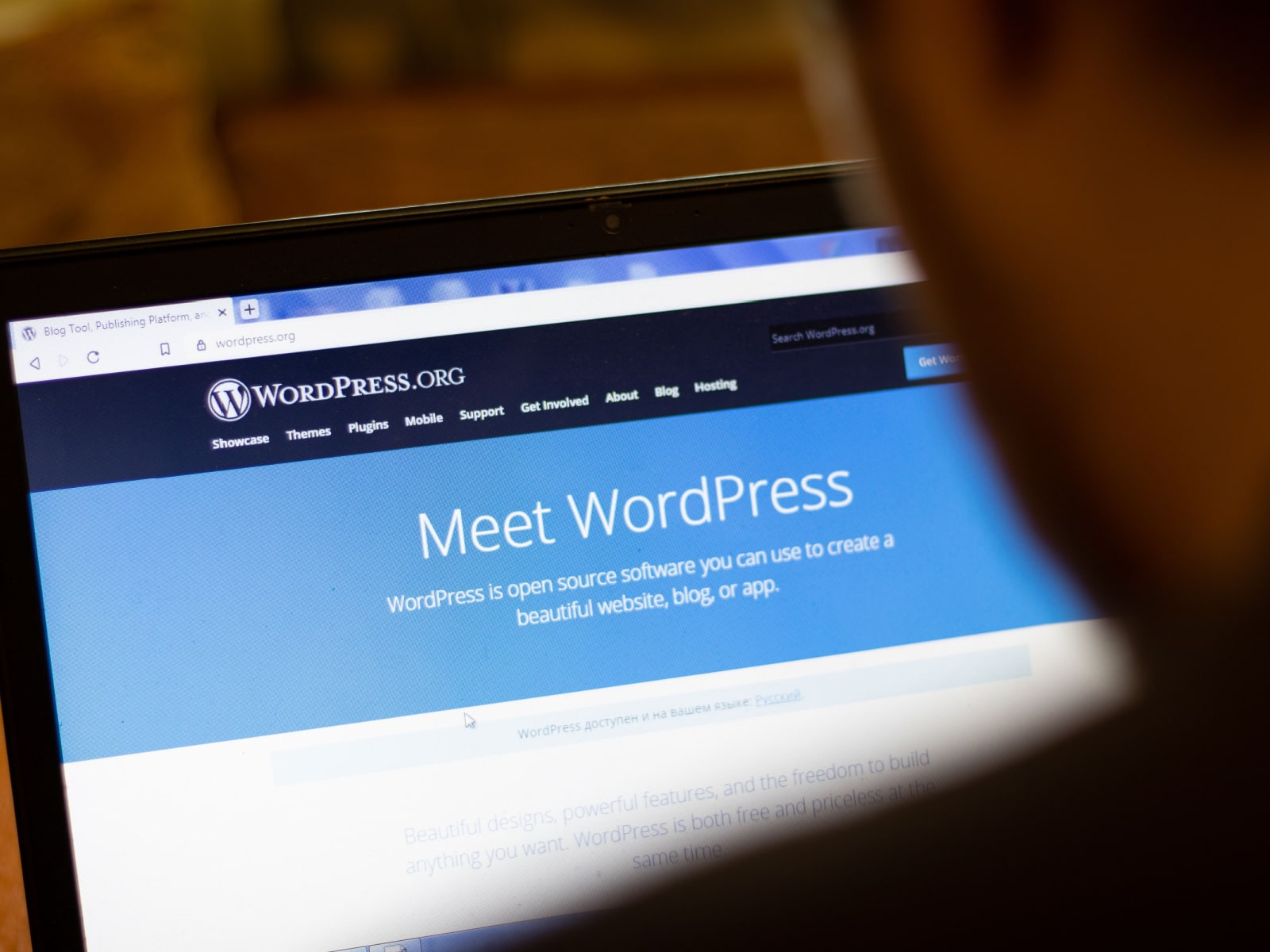 "Meet WordPress" written across a laptop.